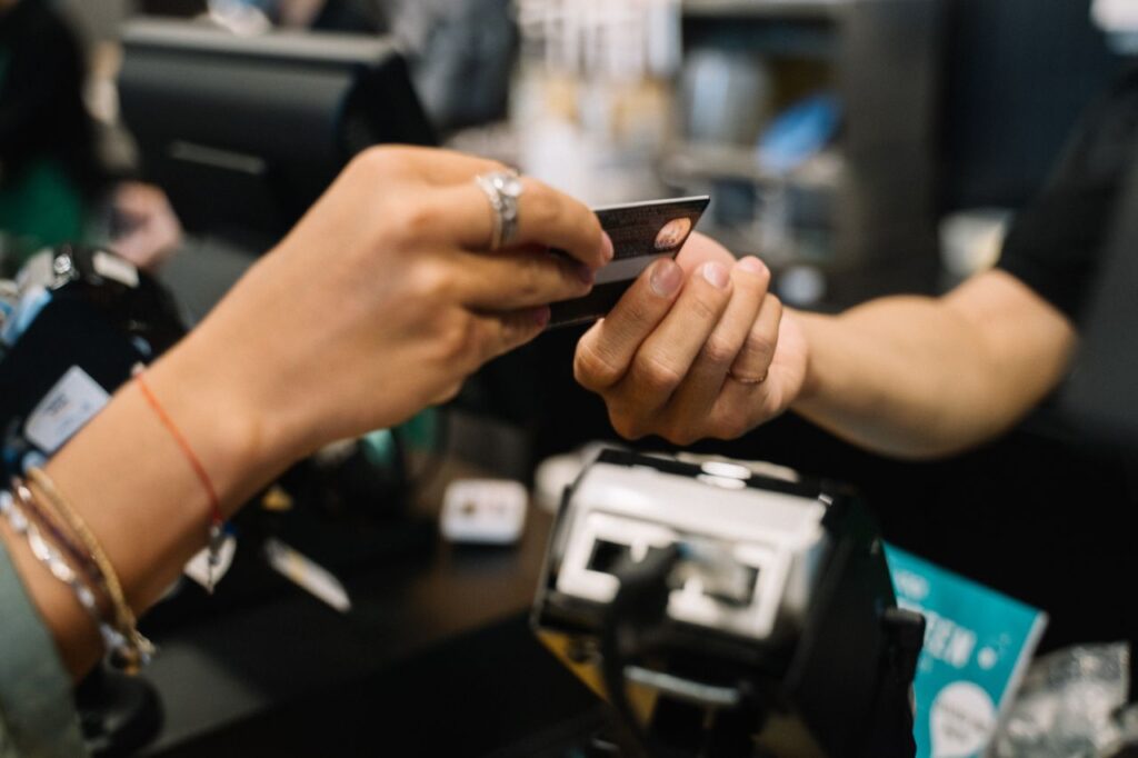 Crafting Captivating Headlines: Your awesome post title goes here Close-up of hands completing a payment transaction at a retail checkout using a bank card.