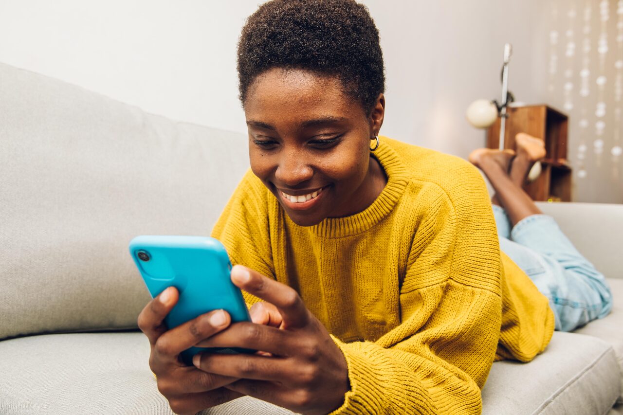 Smiling woman using a digital VAS platform on her phone